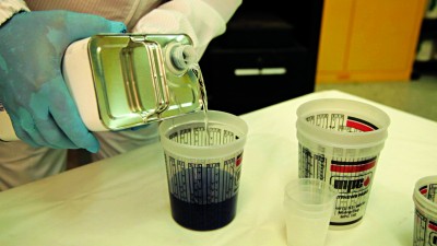 Cups may be available that indicate specific paint mixing ratios on the side.