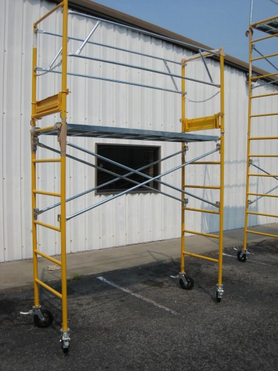 A rolling scaffold needs locking casters (i.e. wheels) and guard rails for safety.