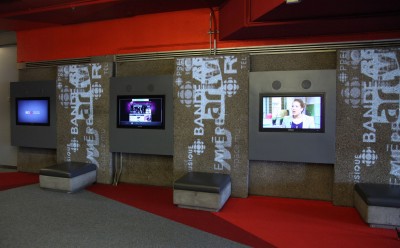 Moving logos are digitally projected onto the walls at either end of the concourse.