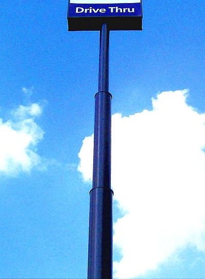 Many free-standing ‘high-rise’ sign structures near major highways are supported by single poles with a telescoping configuration.