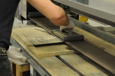 The signs are ‘belted’ to reveal the metallic content in their raised foreground areas.