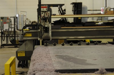 Once approved, the graphics are converted for the computer numerical control (CNC) routing of reusable wax sheets to create the mould.