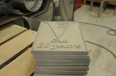 The signs are sandblasted, creating tiny abrasions that will help clearcoats and paints adhere to their surface.