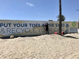 Workhorse Signs had to overcome sand and heat while installing a graphic on a brick beach wall.