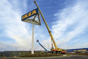 The head structure of the sign is lifted to connect it to the main post.