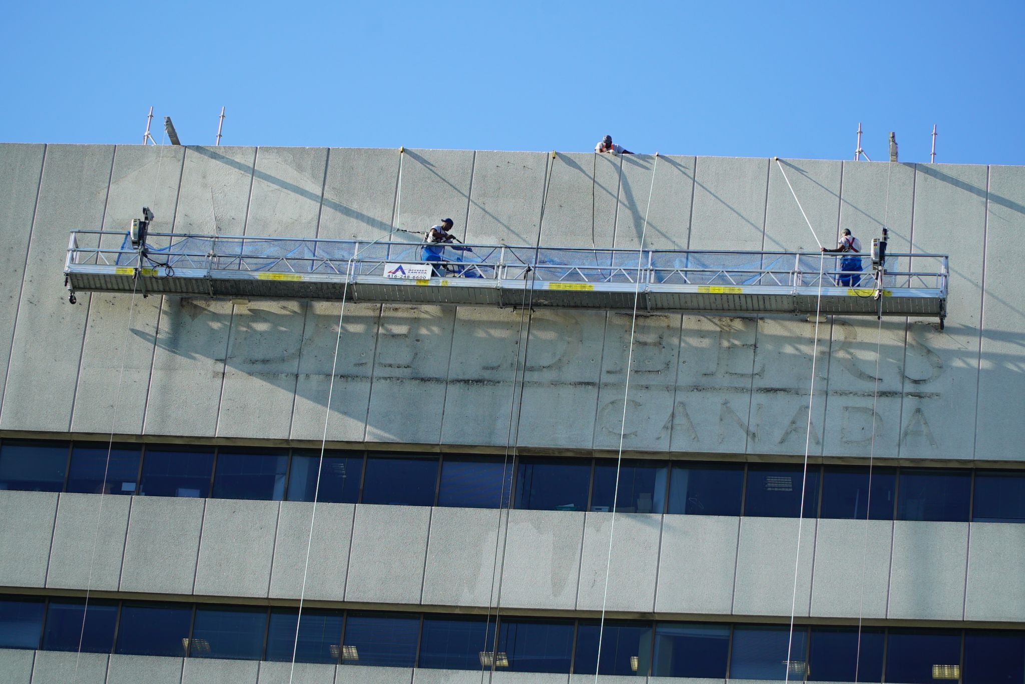Next, the facade was power-washed and cleaned before the new sign was installed.