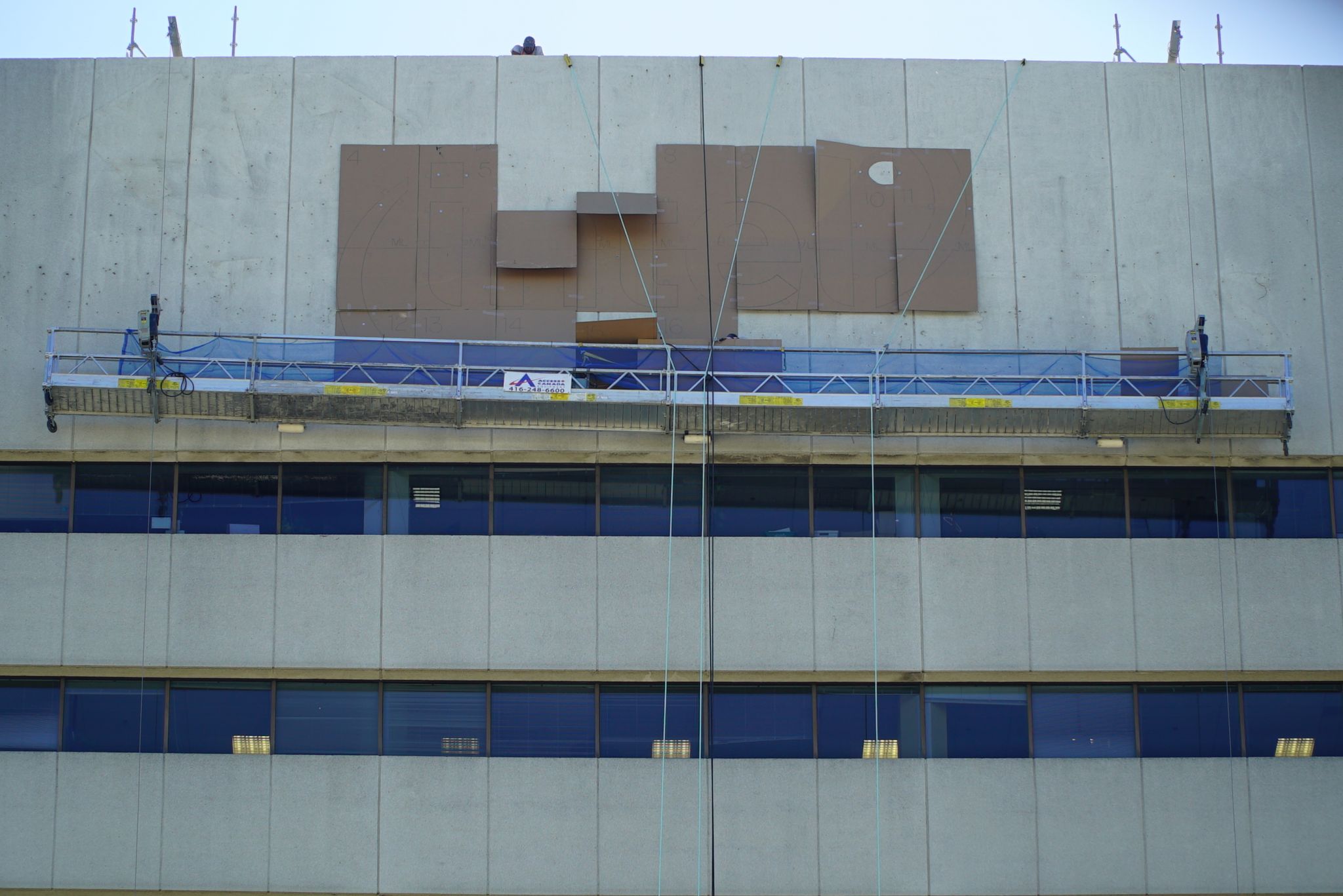 First, the sign’s pattern was laid out on the wall followed by drilling and preparing the facade for the new letters.