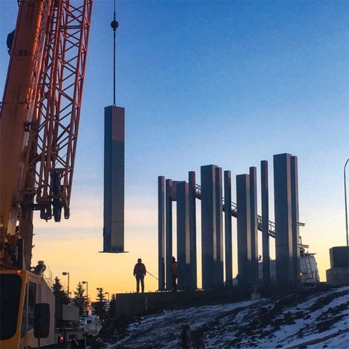 The hollow structural sections (HSS) were hoisted in place for installation. The installation crew were required to be tied off while working on the concrete pad due to the significant slope of the surrounding area.