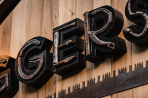 An old hatchet was used to make the ‘L,’ and an old hammer handle was used to create the ‘E.’
