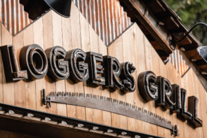 The reclaimed antique wood saw from the old sign was adhered horizontally under the channel letters, which created an underlining effect.