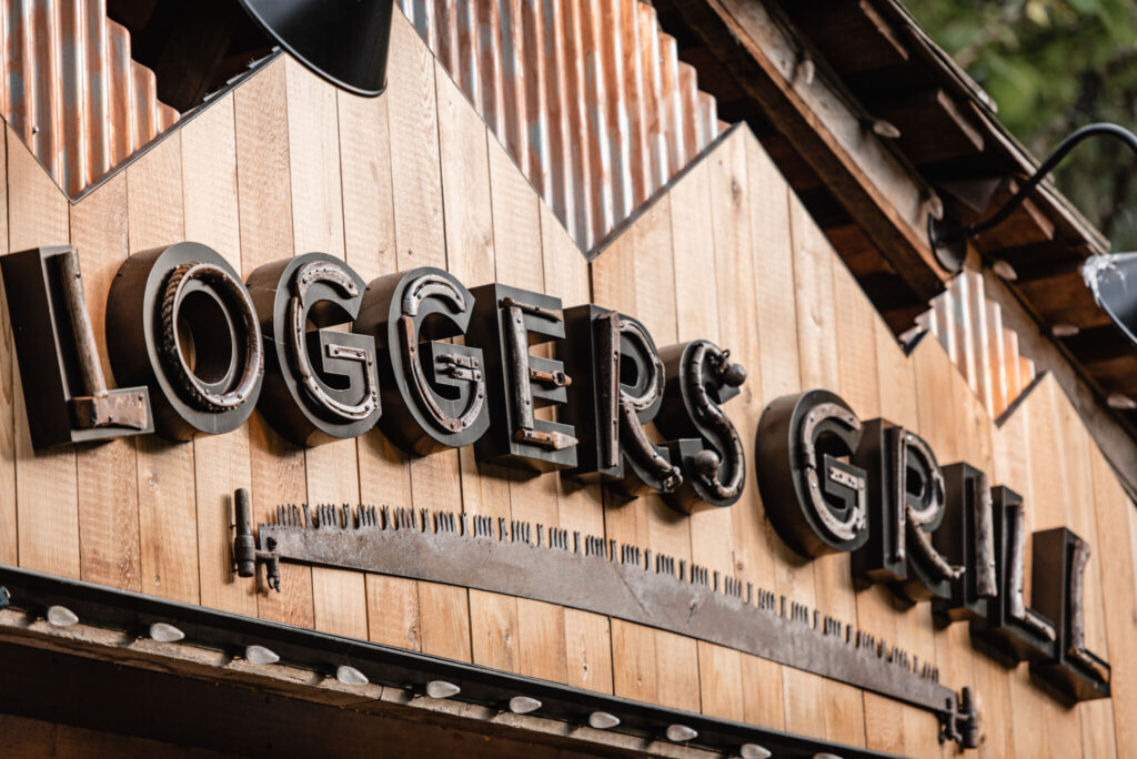 The reclaimed antique wood saw from the old sign was adhered horizontally under the channel letters, which created an underlining effect.