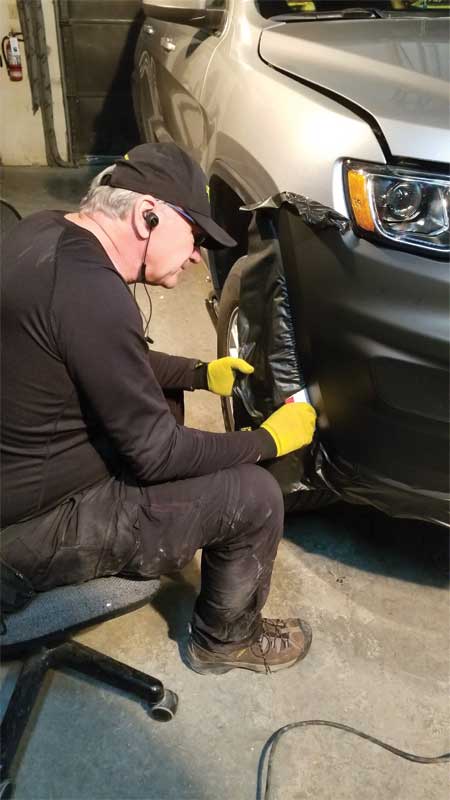 The first step was wrapping the bumper. The team used 3M 2080 film for a better fit around the curves and to achieve a sleek appearance.