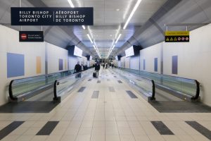 A suite of physical and digital signage has been installed in high-traffic areas throughout the terminal and pedestrian tunnel at Billy Bishop Toronto City Airport, to help promote a new digital guide for arriving passengers. Photo by Hutima – CC 4.0