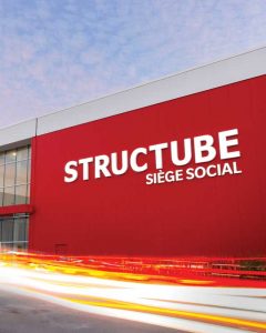 A set of white, face-lit Structube channel letters on an aluminum composite material (ACM) architectural wall.