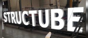 A set of white, face-lit channel letters in the Access Signs shop.