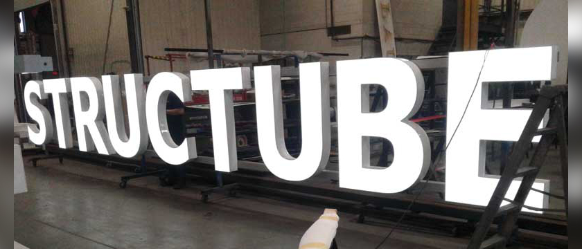 A set of white, face-lit channel letters in the Access Signs shop.