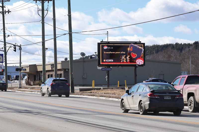 The add on a billboard at the side of the road.