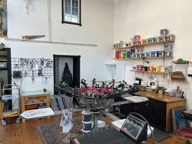 Sugarbomb Toronto's office space with screenprinting tools and boxes of paint.