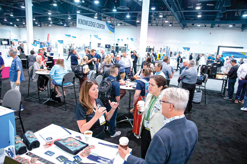 Women connecting in person at the expo.