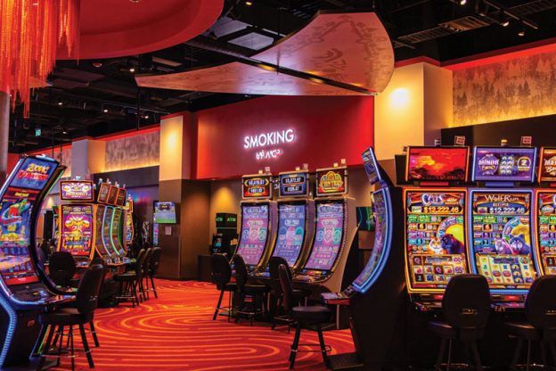 A no-smoking sign seen behind several slot machines.