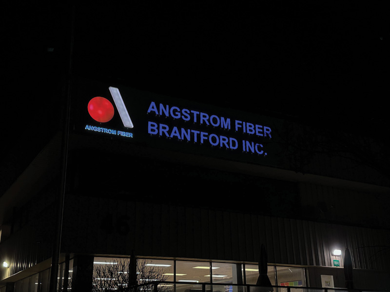 The exterior sign seen in the dark.