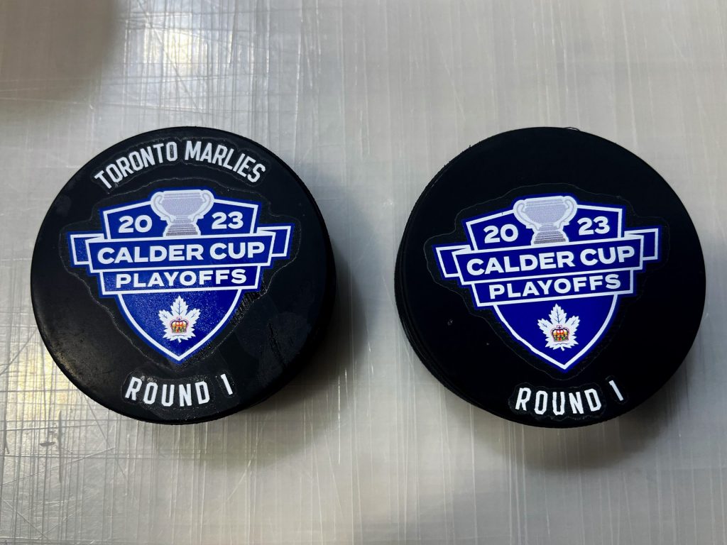 Printed hockey pucks.