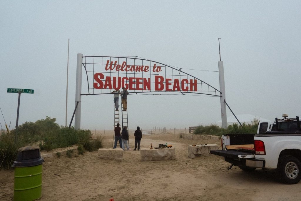 The beach committee changing the sign.