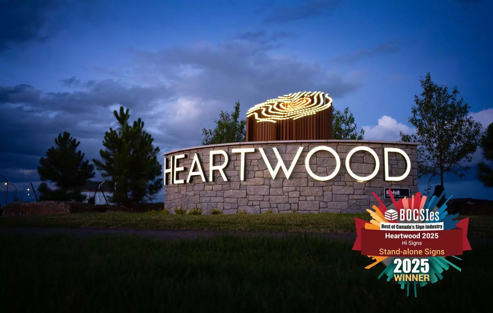The sign illuminated at night.