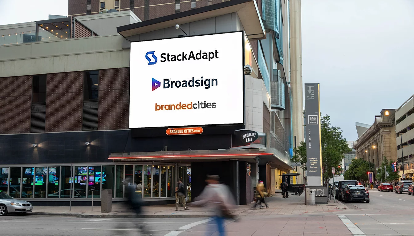 A billboard featuring all three company names and logos.