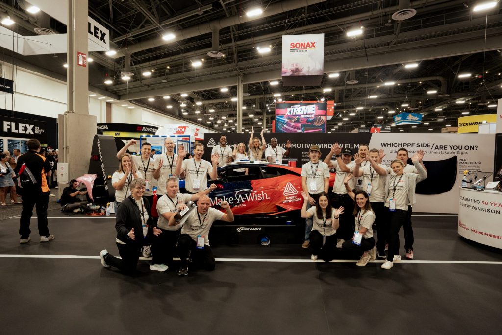 The teens, along with the Avery Dennison personnel, pose for a photo. 