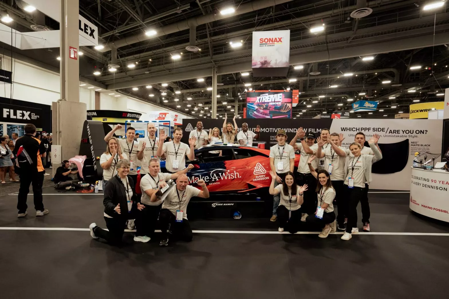 The teens, along with the Avery Dennison personnel, pose for a photo.