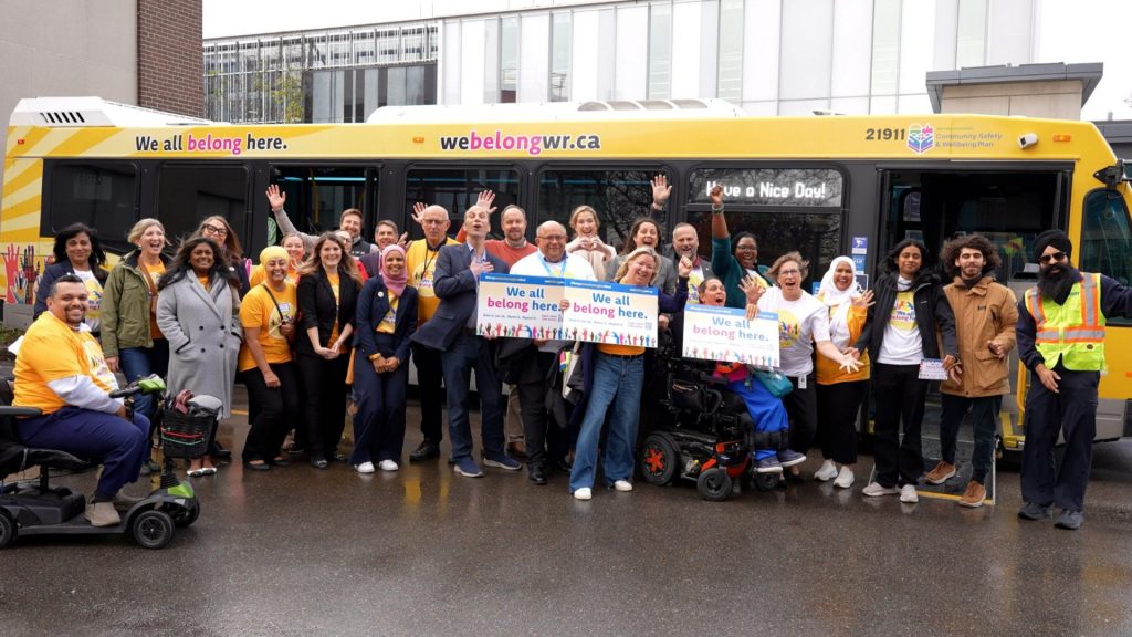 People of Waterloo celebrating the campaign in front of the GRT bus wrap.
