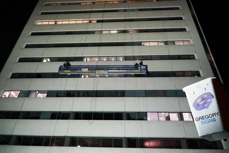 A lift in use for an exterior building sign.