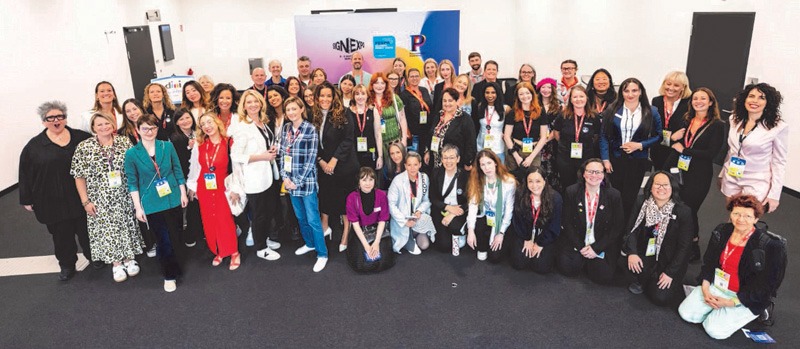 Women in the alliance pose for a photo.