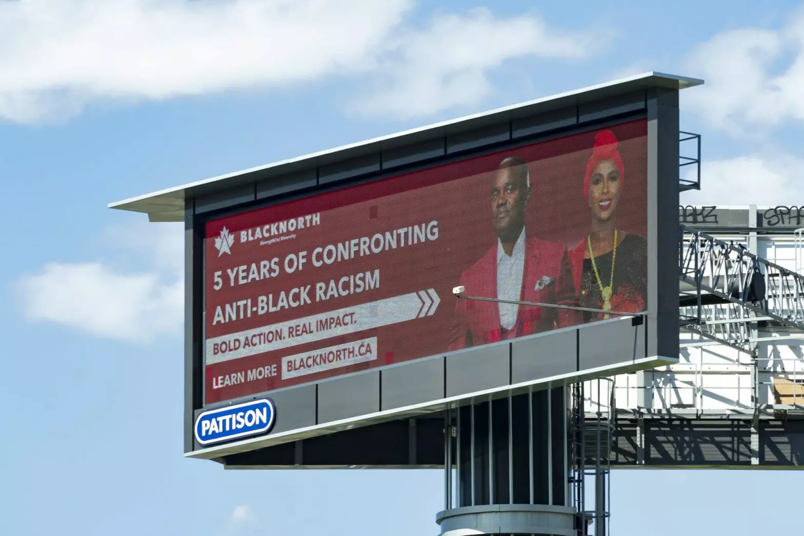The billboard featuring the ad displayed.