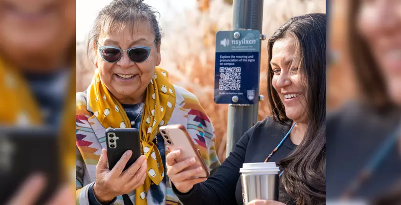 People scan the QR code to listen to the audio signs.