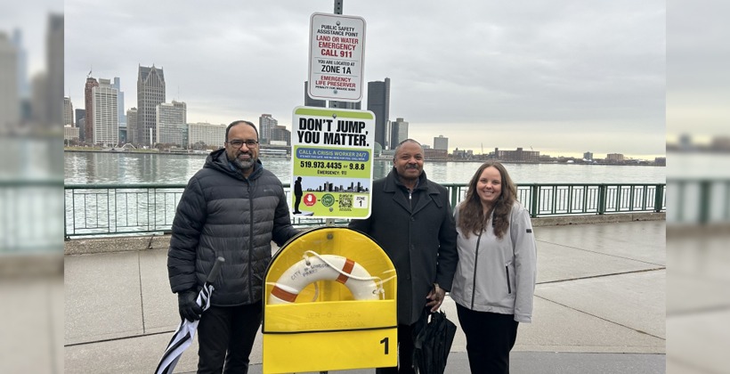 UWindsor members of the Lifeline Windsor Project team stand beside an example of a new COMPASS station on Windsor's waterfront.