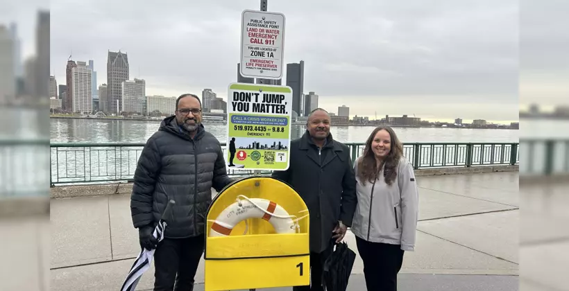 UWindsor members of the Lifeline Windsor Project team stand beside an example of a new COMPASS station on Windsor's waterfront.