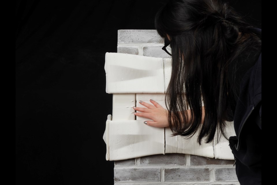 A person touches the tactile surface.