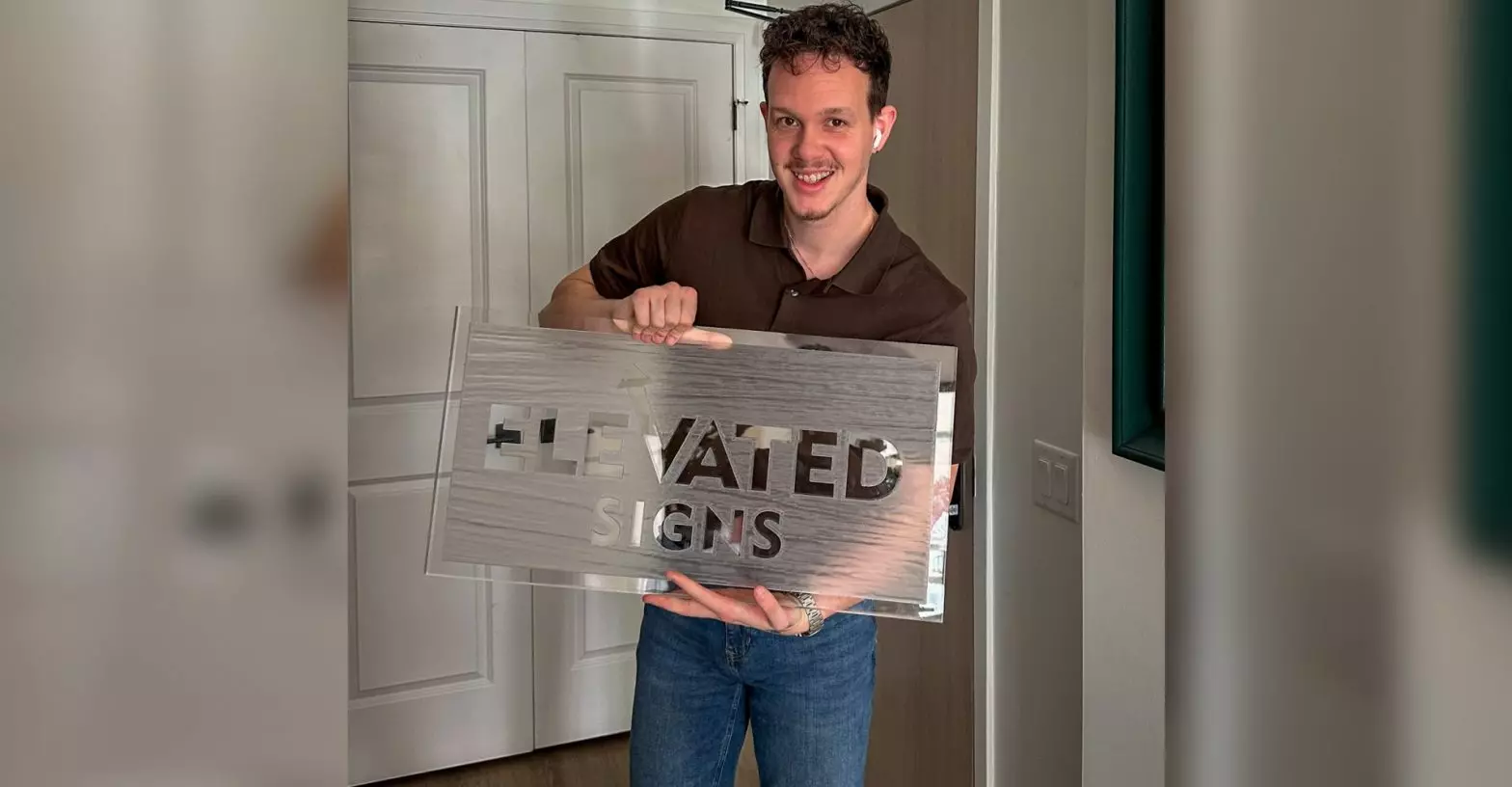 A Terence Davis headshot with an Elevated Signs sign in his hands.