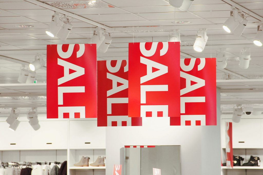 Sale signs hanging from a ceiling.