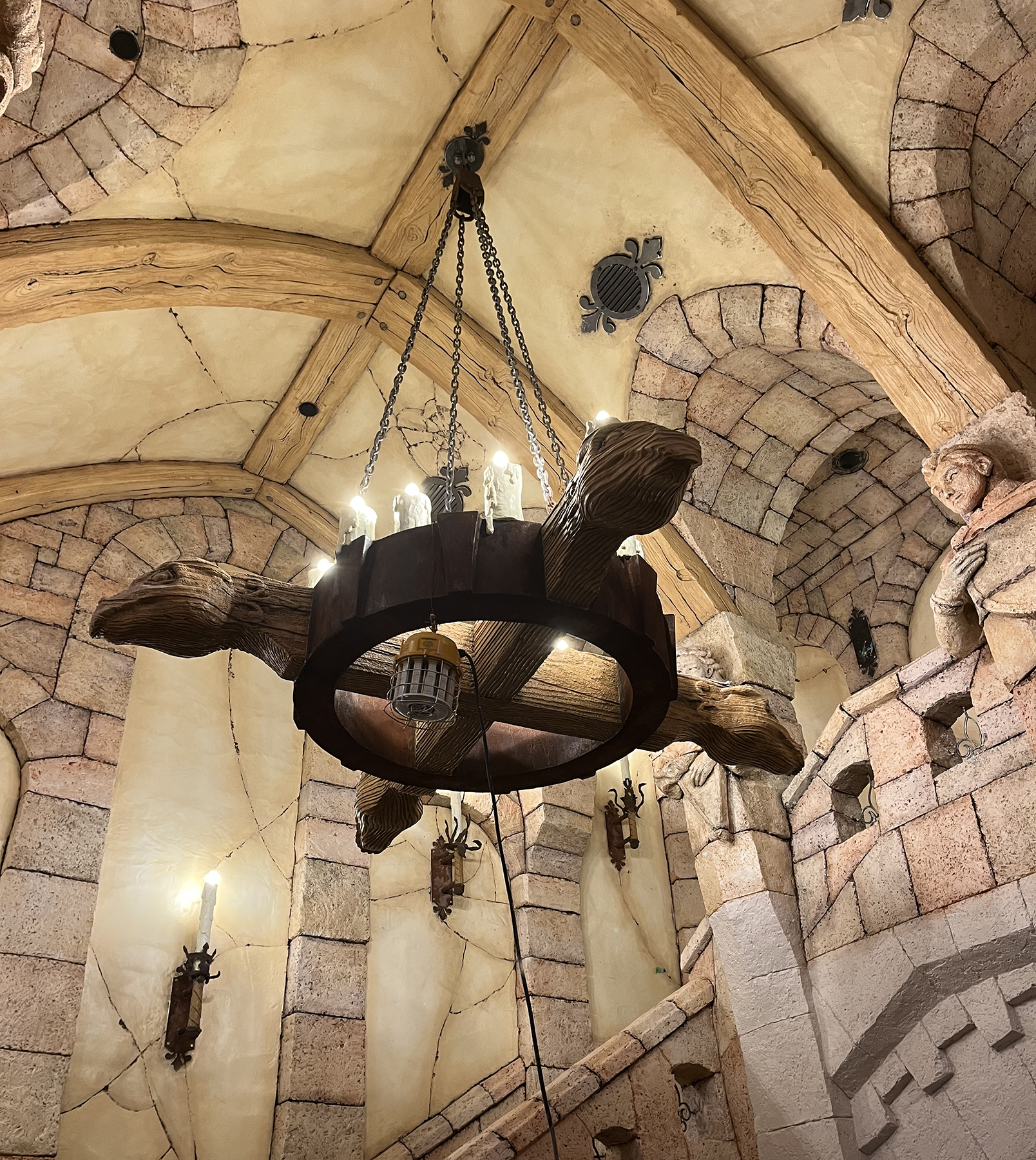 Chandelier: Handcrafted interior with a tall ceiling and a timber chandelier.