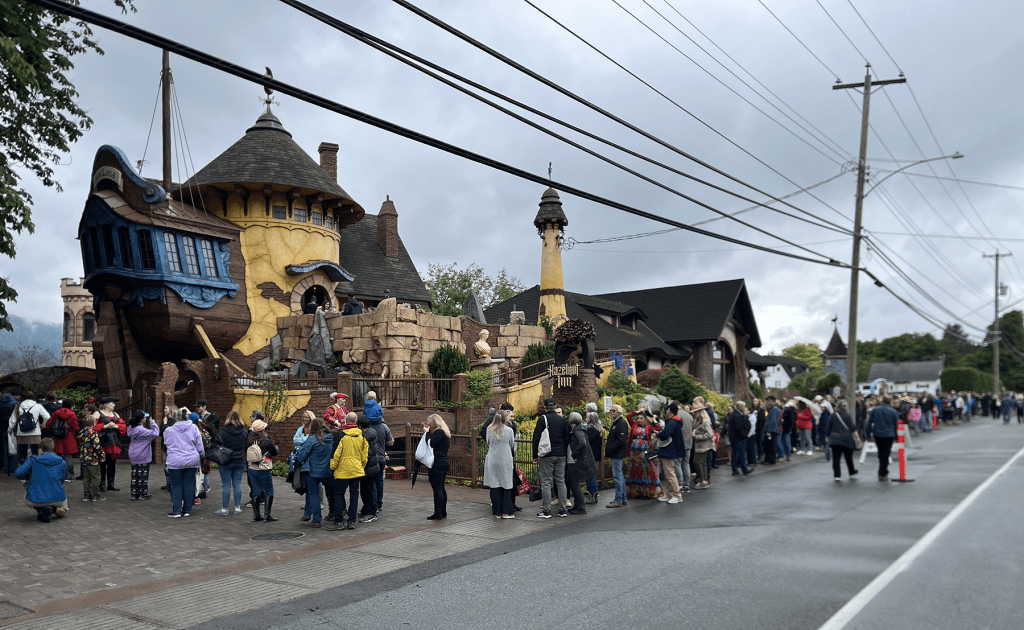 People standing in queue outside the inn.