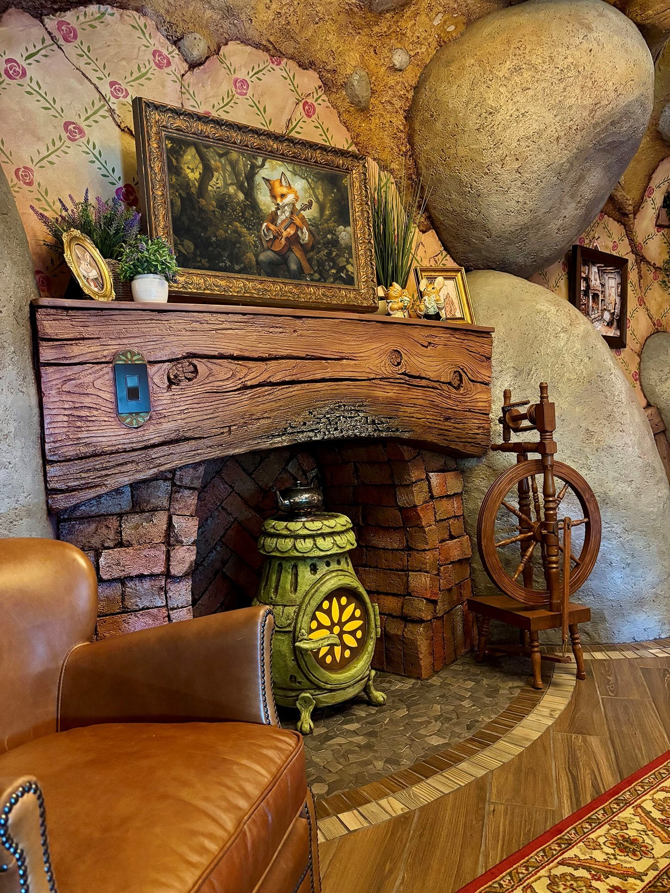 Fireplace: While modern in function, the features appear to be antiquated. The potbellied stove glows with a “fire” inside. However, guests who study the fireplace mantle will notice the slightly charred timber, which is carved from concrete and painted exquisitely. The photo on the mantle is a hidden television for guests.