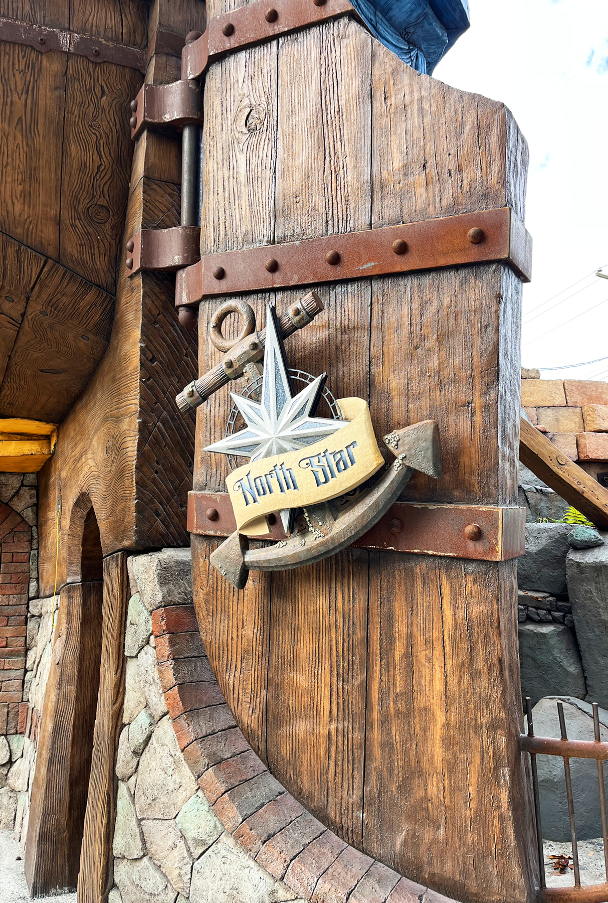 "North Star" sign with anchor and compass star motif on a weathered wooden building exterior