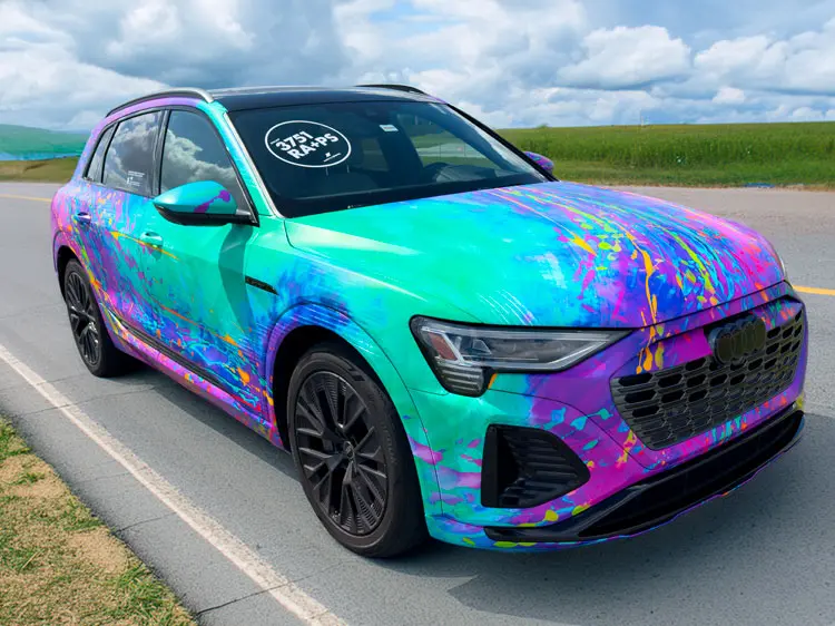 Rear and side view of a colorful iridescent Audi e-tron with ORAFOL-branded decal on the rear window.