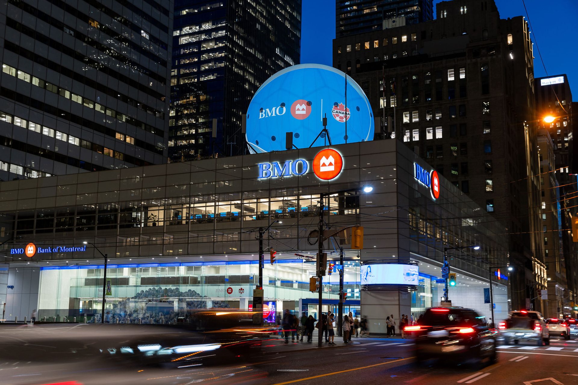 BMO Bank of Montreal branch at night with a large soccer ball display on the rooftop, co-branded with Canada Soccer