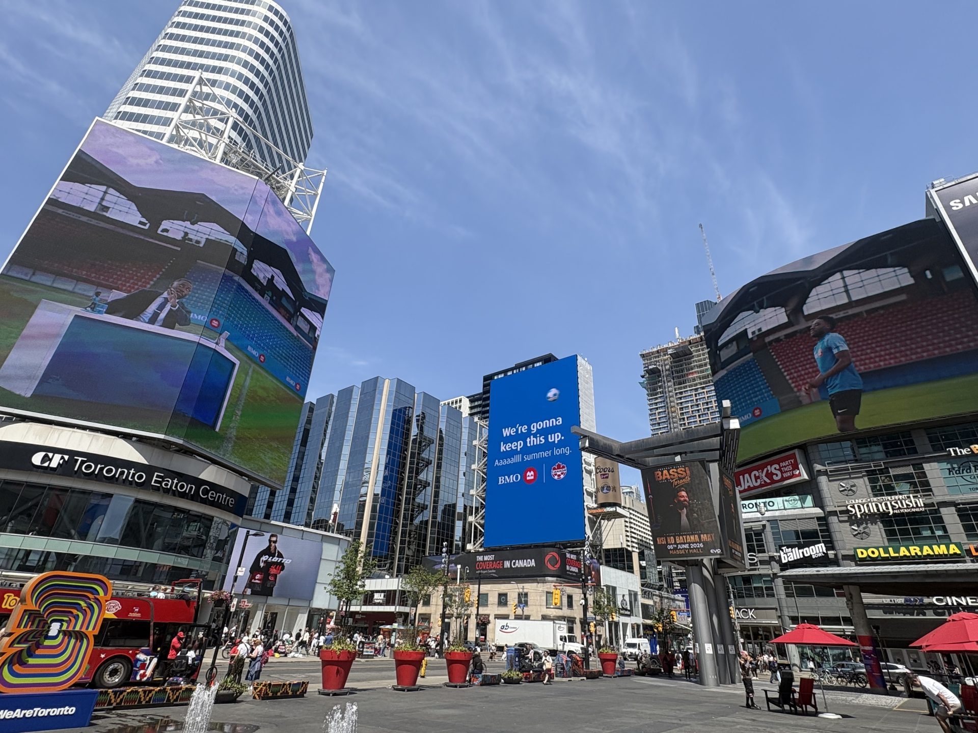 BMO Canada Soccer billboard reading "We're gonna keep this up. Aaaaalll summer long." at Sankofa Square, Toronto.
