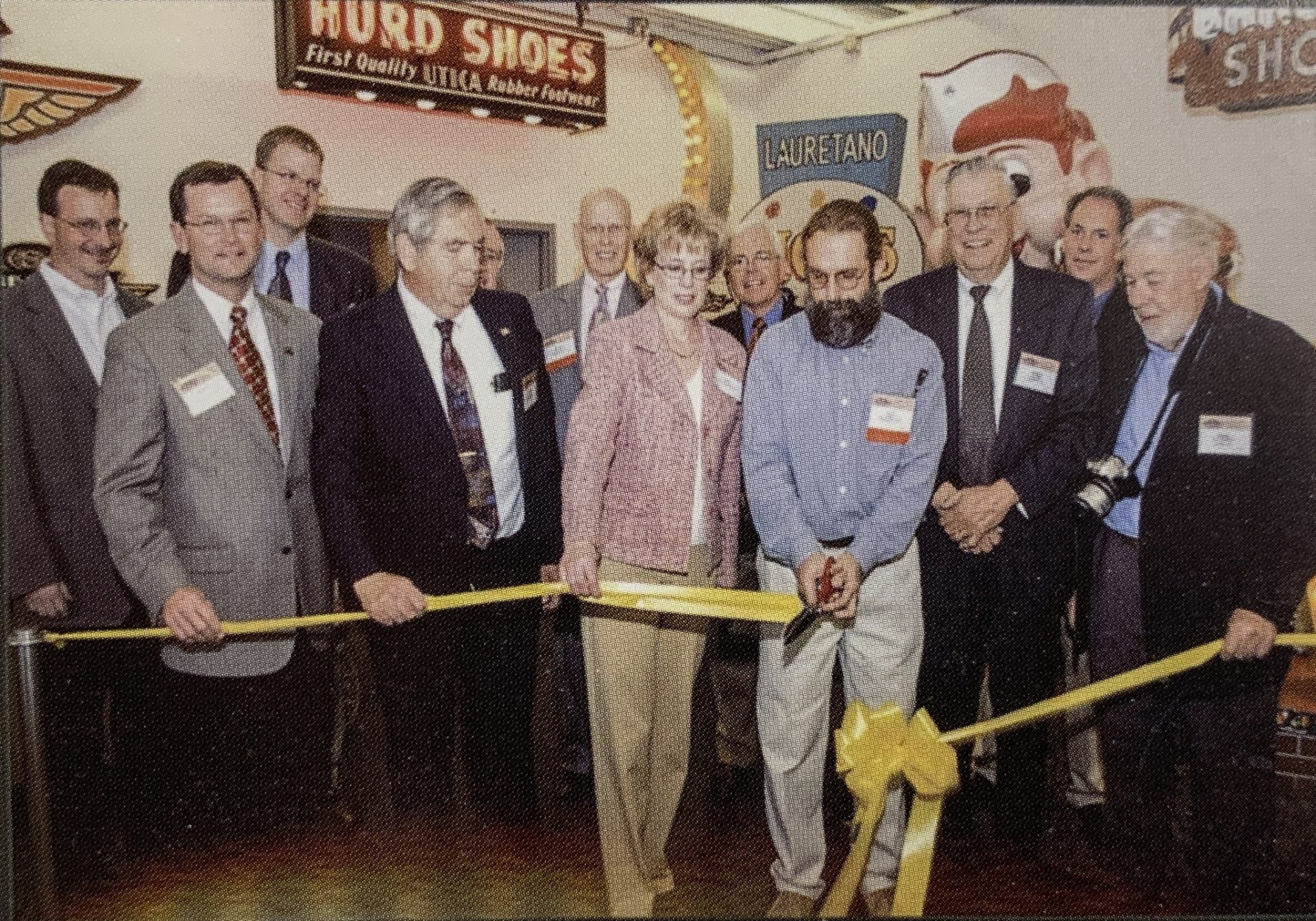 Jim Weinel and several others cutting the ribbon at the American Sign Museum.