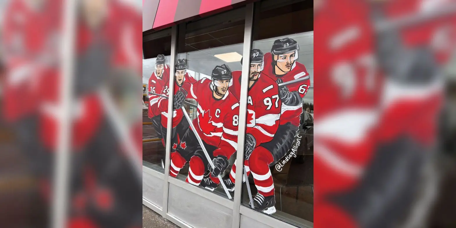 Storefront windows feature painted illustrations of five Team Canada hockey players in red jerseys with sticks raised.